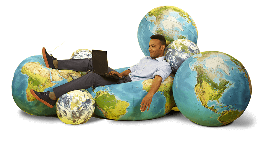 Man ligt op wereldbollen met laptop op schoot